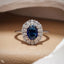 Blue Oval Halo Engagement Ring with Floral Accent Stones