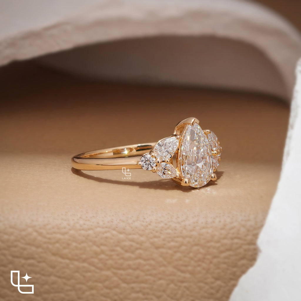 Pear Cut Engagement Ring with Matching Side Stones and Round Accent Details