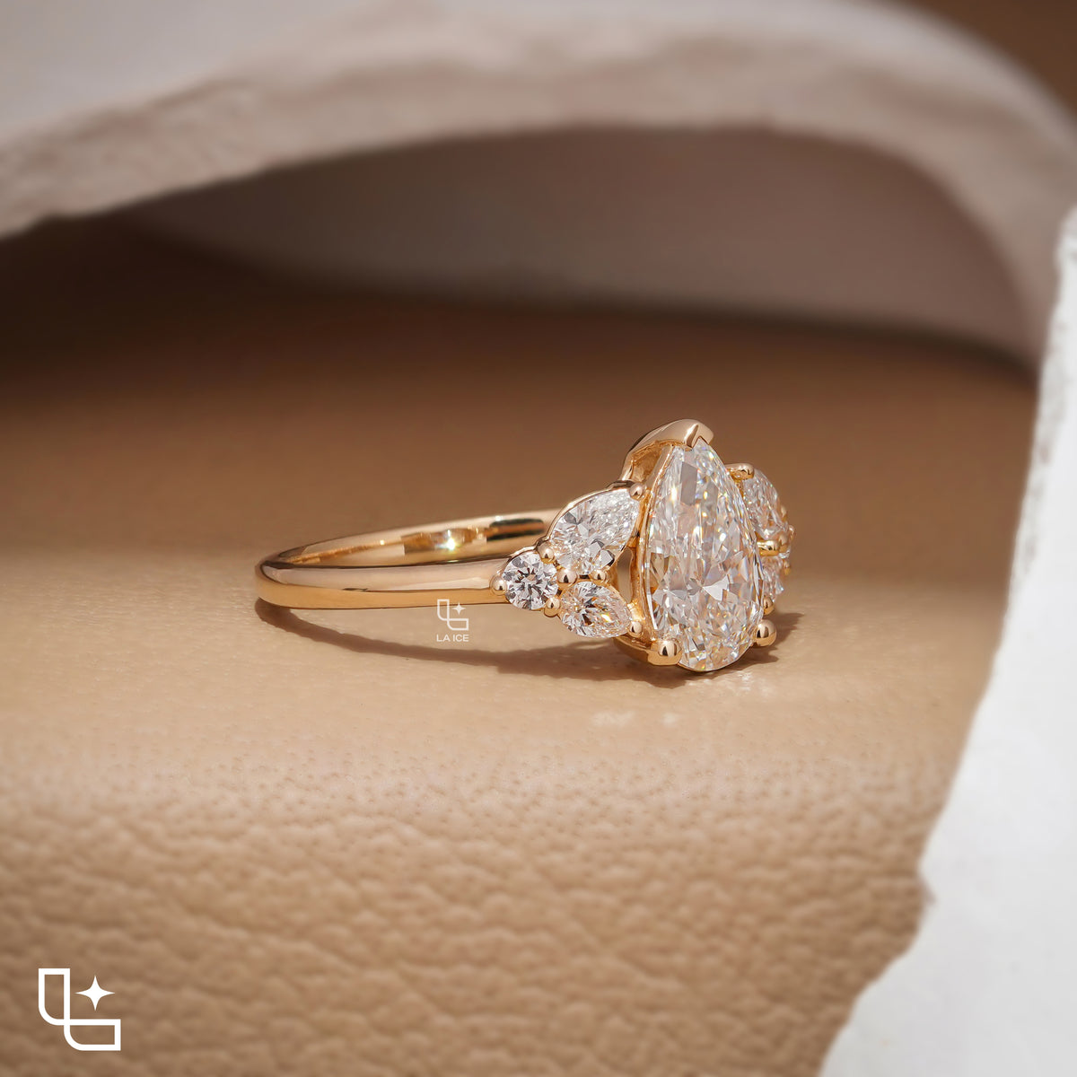 Pear Cut Engagement Ring with Matching Side Stones and Round Accent Details