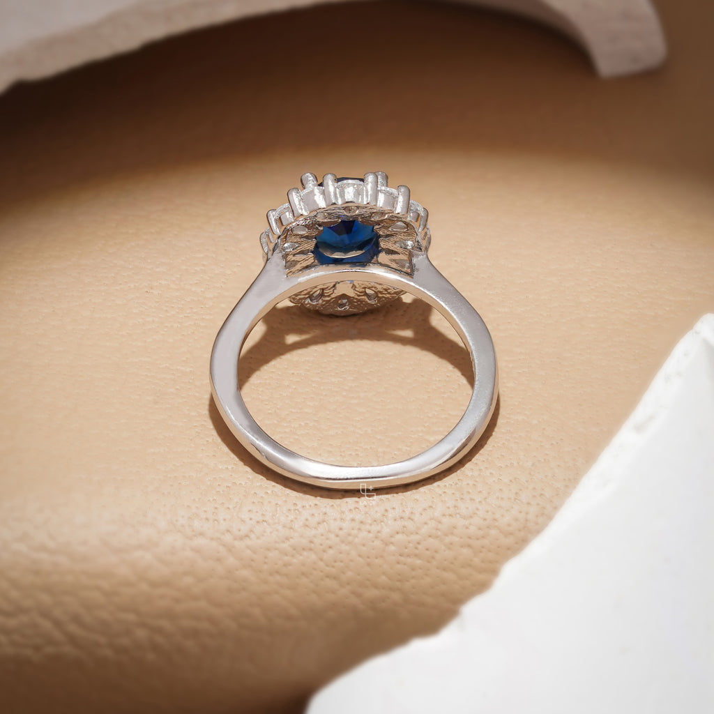 Blue Oval Halo Engagement Ring with Floral Accent Stones