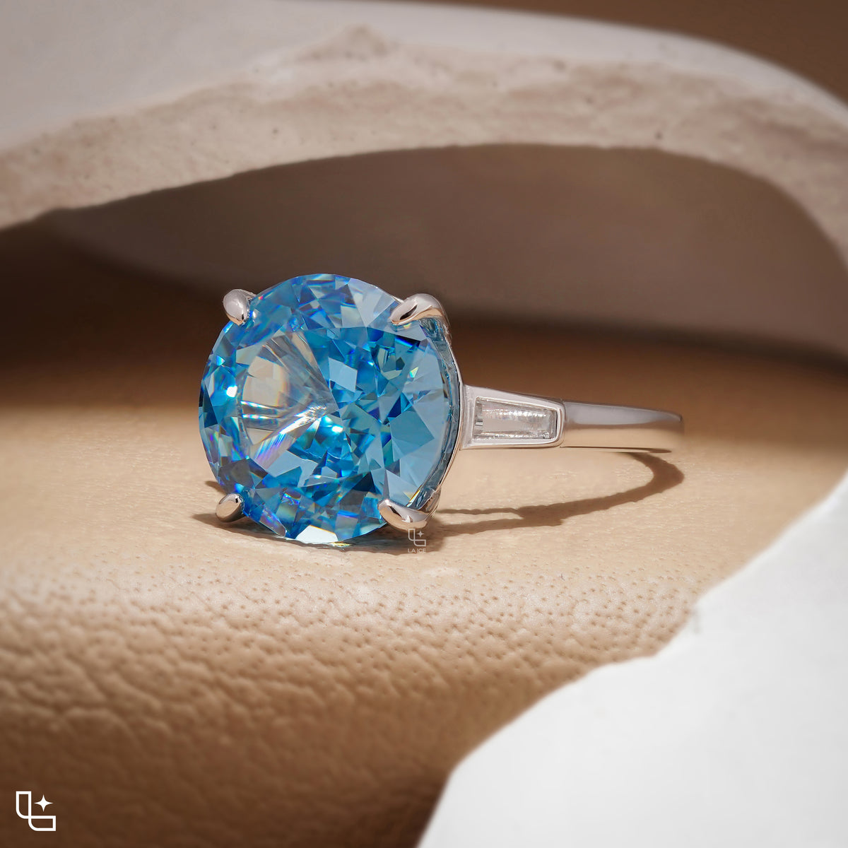 Round Blue Center Stone Solitaire Ring with Baguette Side Accents