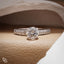 Round Cut Pavé Engagement Ring with Brilliant Center Stone and Sparkling Side Stones