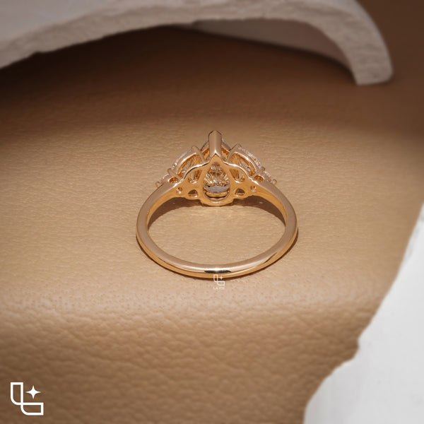 Pear Cut Engagement Ring with Matching Side Stones and Round Accent Details