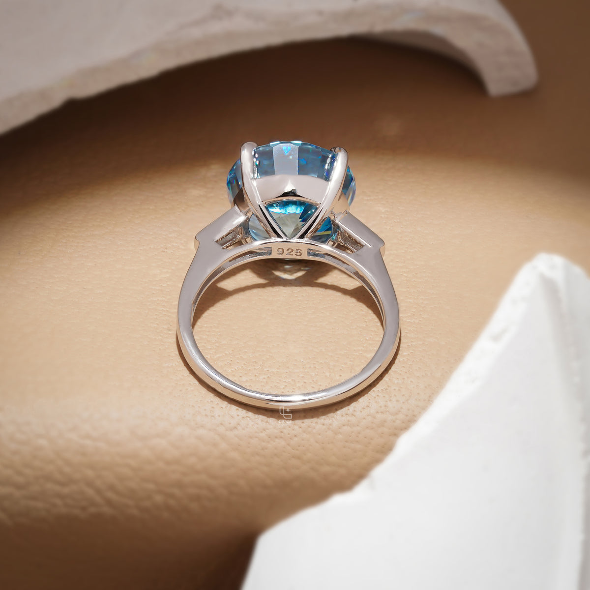 Round Blue Center Stone Solitaire Ring with Baguette Side Accents