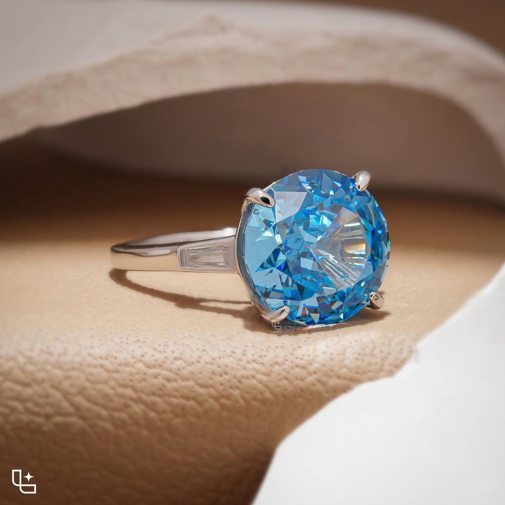 Round Blue Center Stone Solitaire Ring with Baguette Side Accents