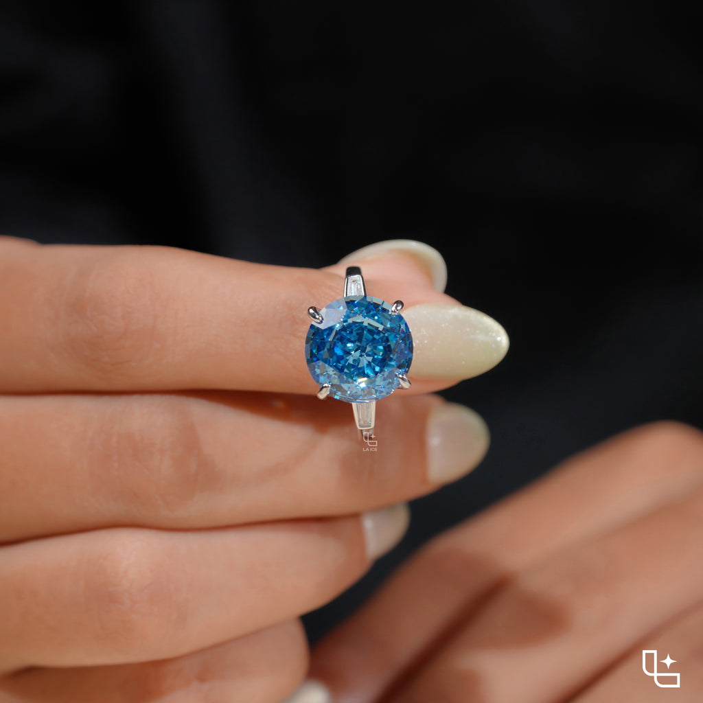 Round Blue Center Stone Solitaire Ring with Baguette Side Accents