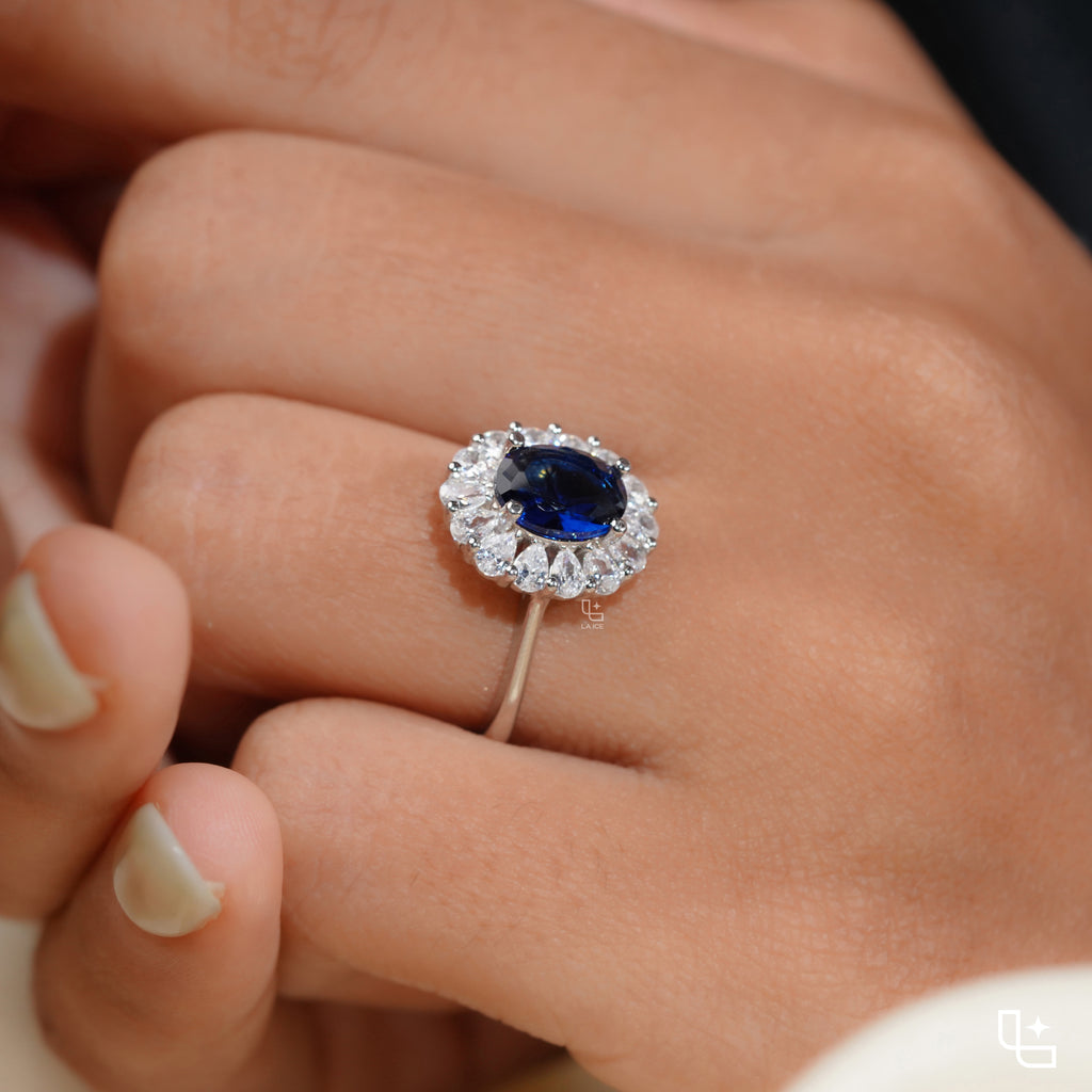 Blue Oval Halo Engagement Ring with Floral Accent Stones