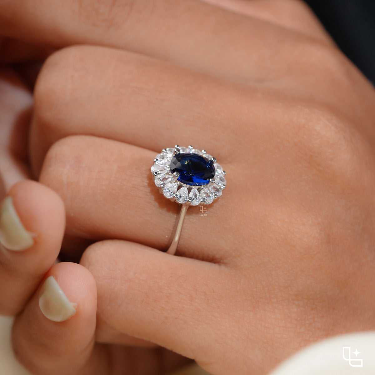 Blue Oval Halo Engagement Ring with Floral Accent Stones
