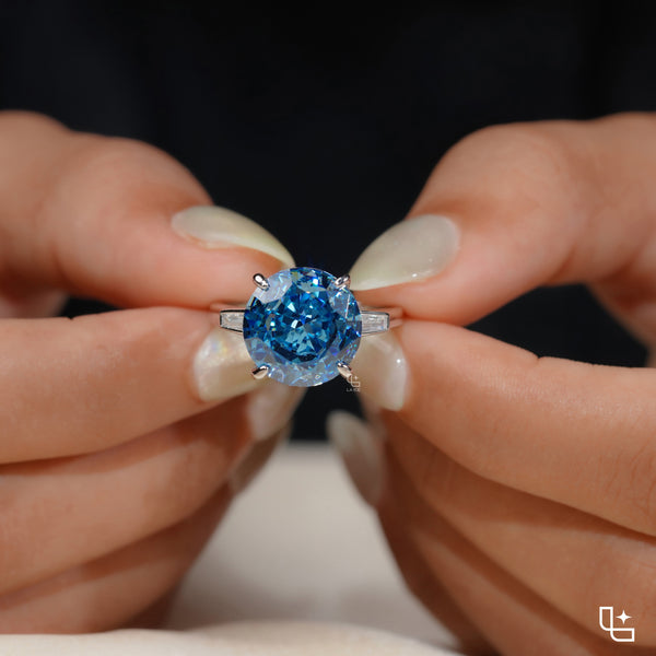 Round Blue Center Stone Solitaire Ring with Baguette Side Accents