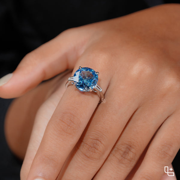 Round Blue Center Stone Solitaire Ring with Baguette Side Accents
