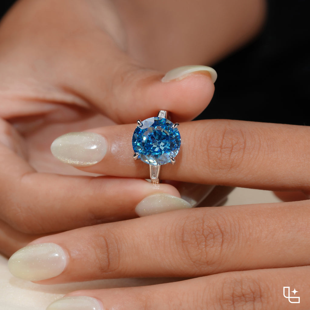 Round Blue Center Stone Solitaire Ring with Baguette Side Accents