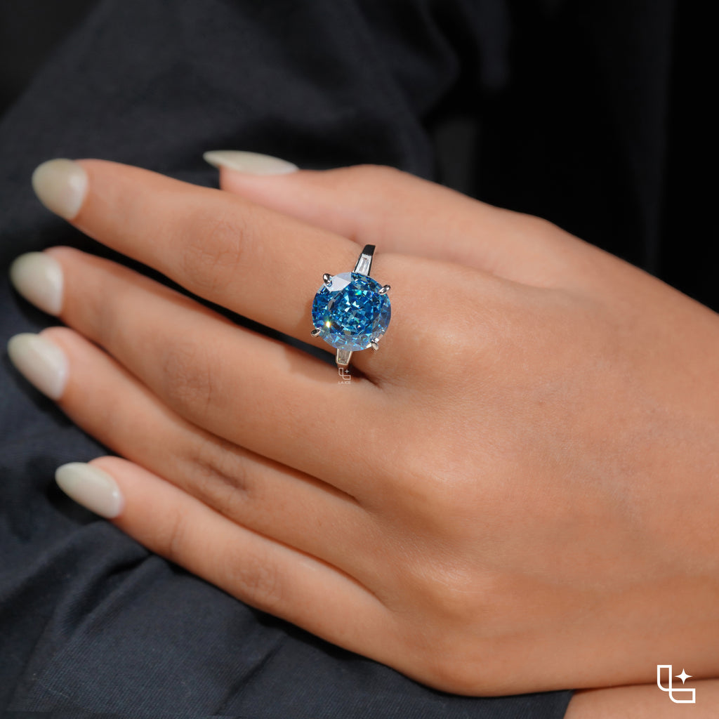 Round Blue Center Stone Solitaire Ring with Baguette Side Accents
