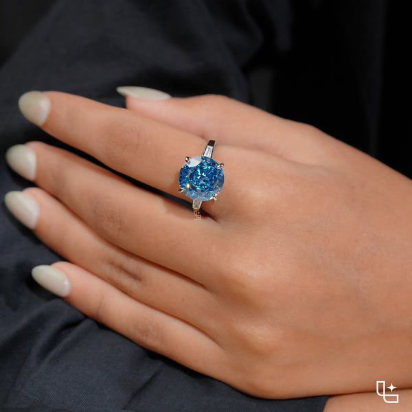 Round Blue Center Stone Solitaire Ring with Baguette Side Accents