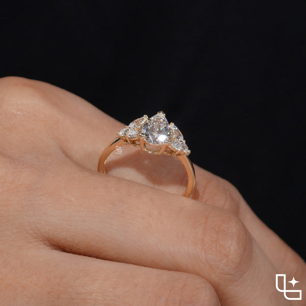 Pear Cut Engagement Ring with Matching Side Stones and Round Accent Details