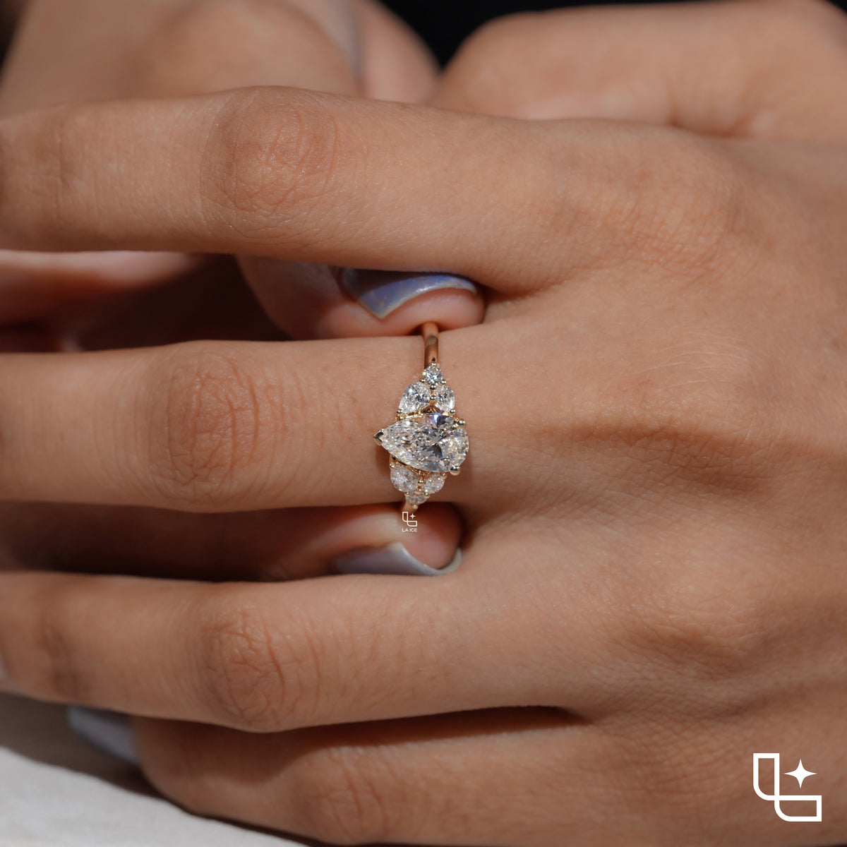 Pear Cut Engagement Ring with Matching Side Stones and Round Accent Details