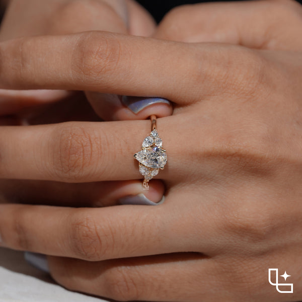 Pear Cut Engagement Ring with Matching Side Stones and Round Accent Details