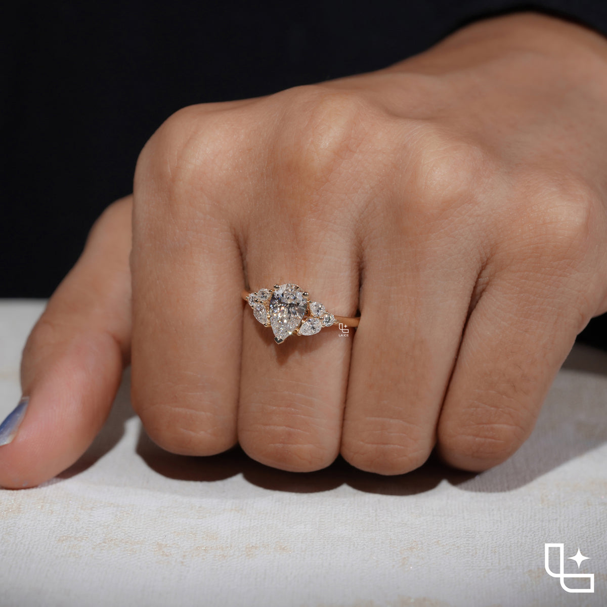 Pear Cut Engagement Ring with Matching Side Stones and Round Accent Details