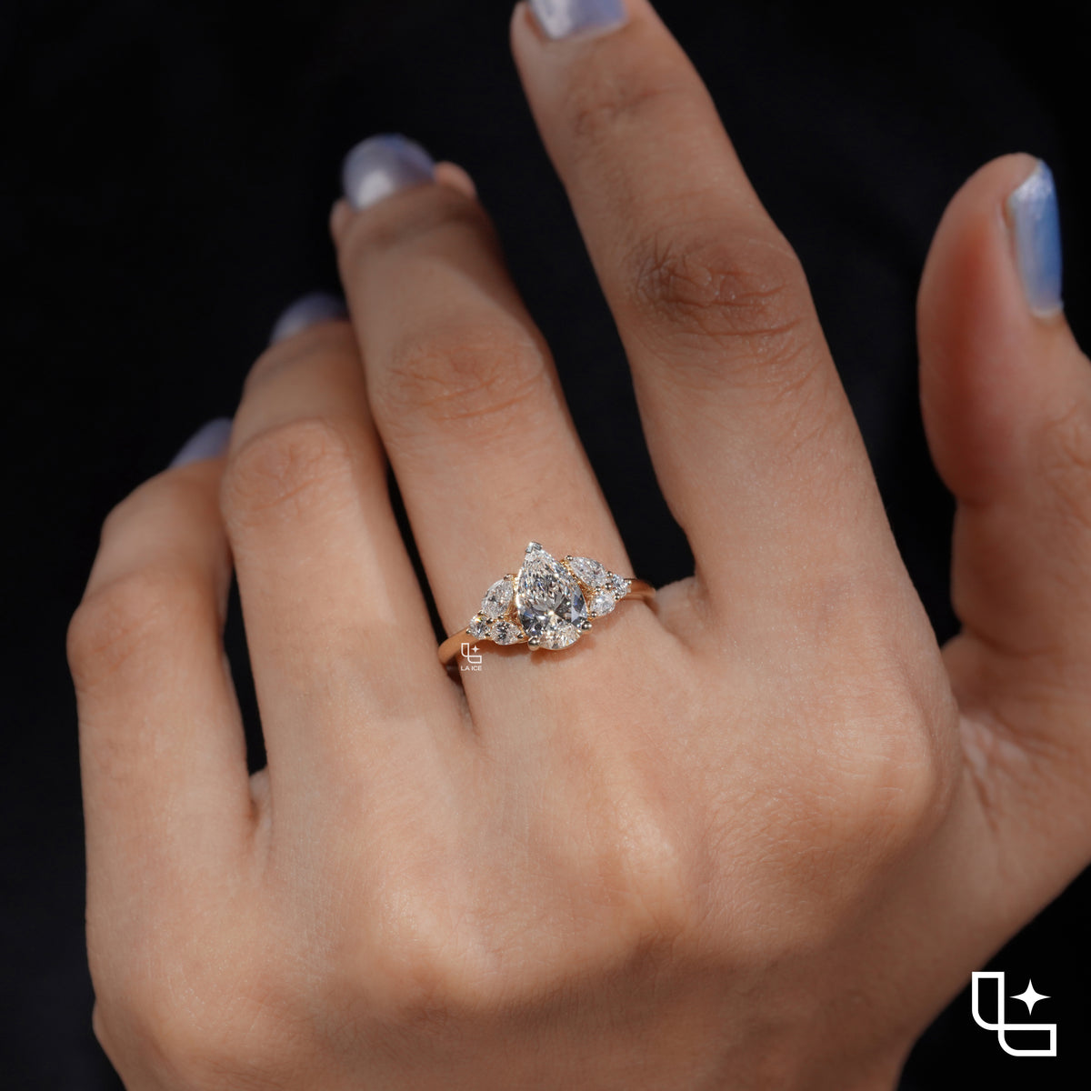 Pear Cut Engagement Ring with Matching Side Stones and Round Accent Details