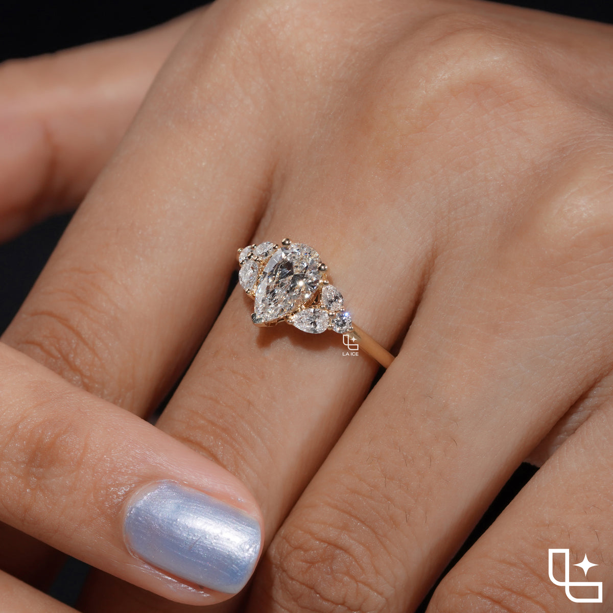 Pear Cut Engagement Ring with Matching Side Stones and Round Accent Details