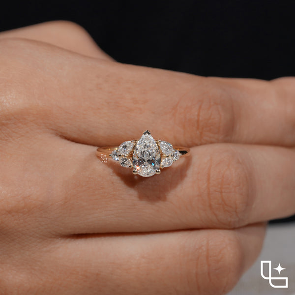Pear Cut Engagement Ring with Matching Side Stones and Round Accent Details