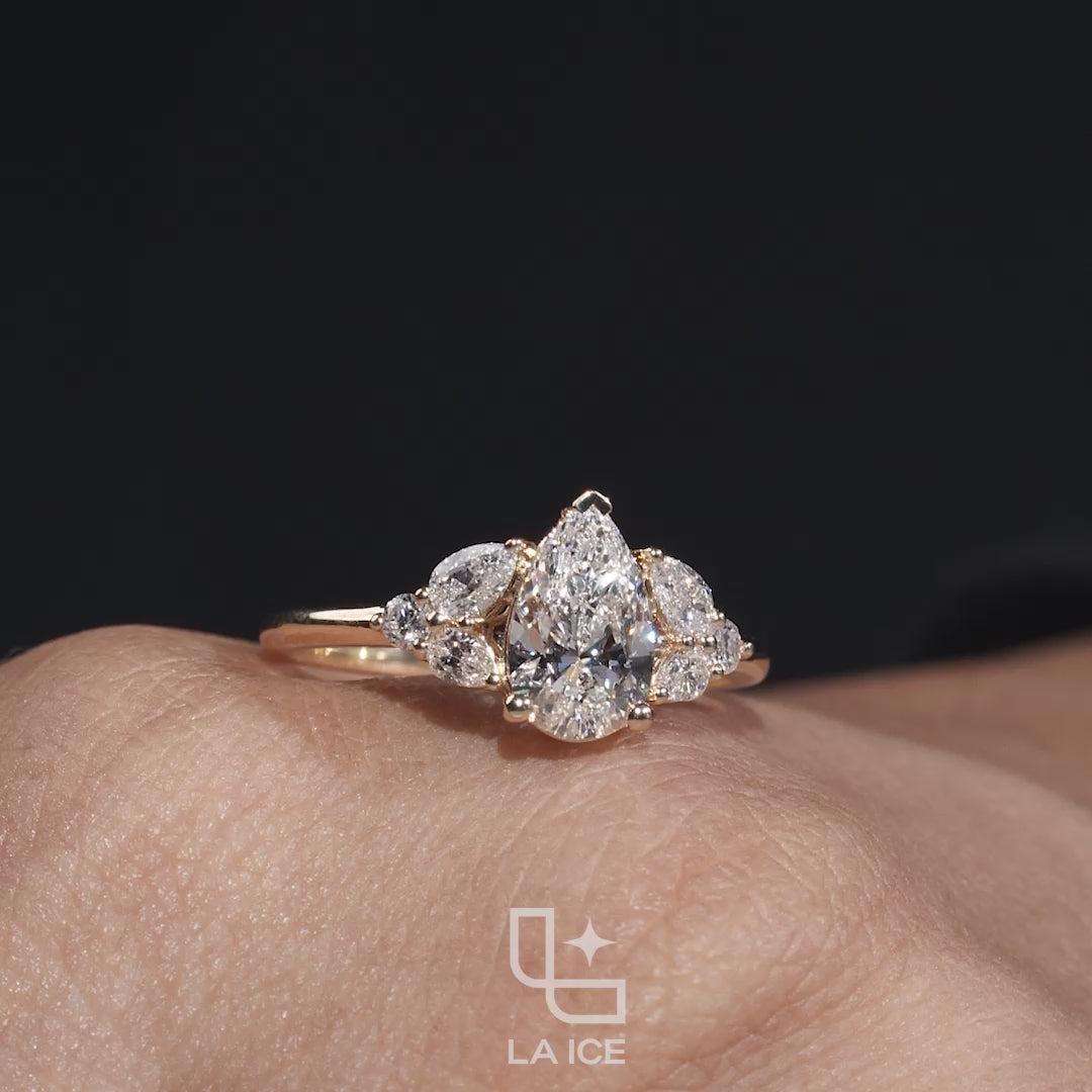 Pear Cut Engagement Ring with Matching Side Stones and Round Accent Details