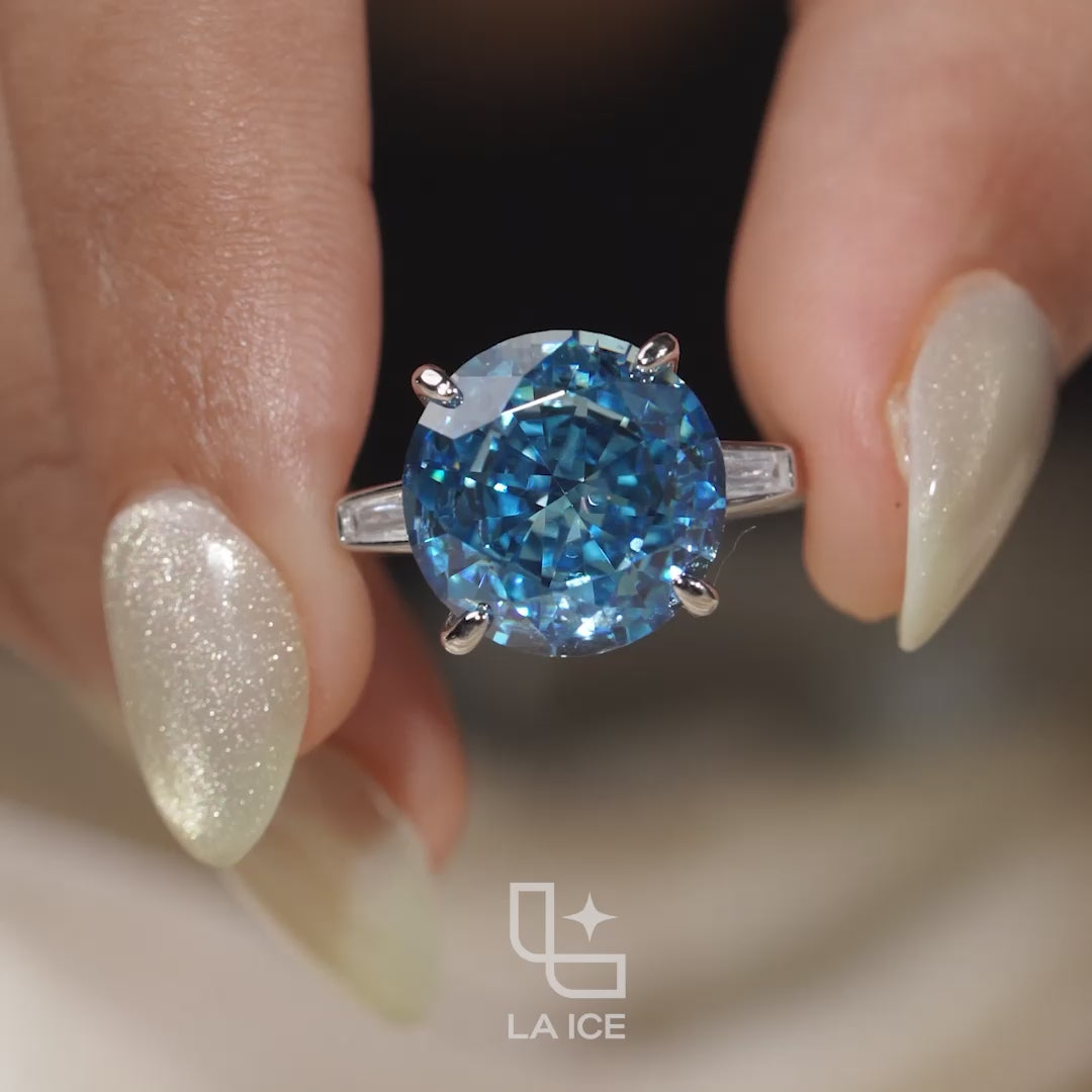 Round Blue Center Stone Solitaire Ring with Baguette Side Accents
